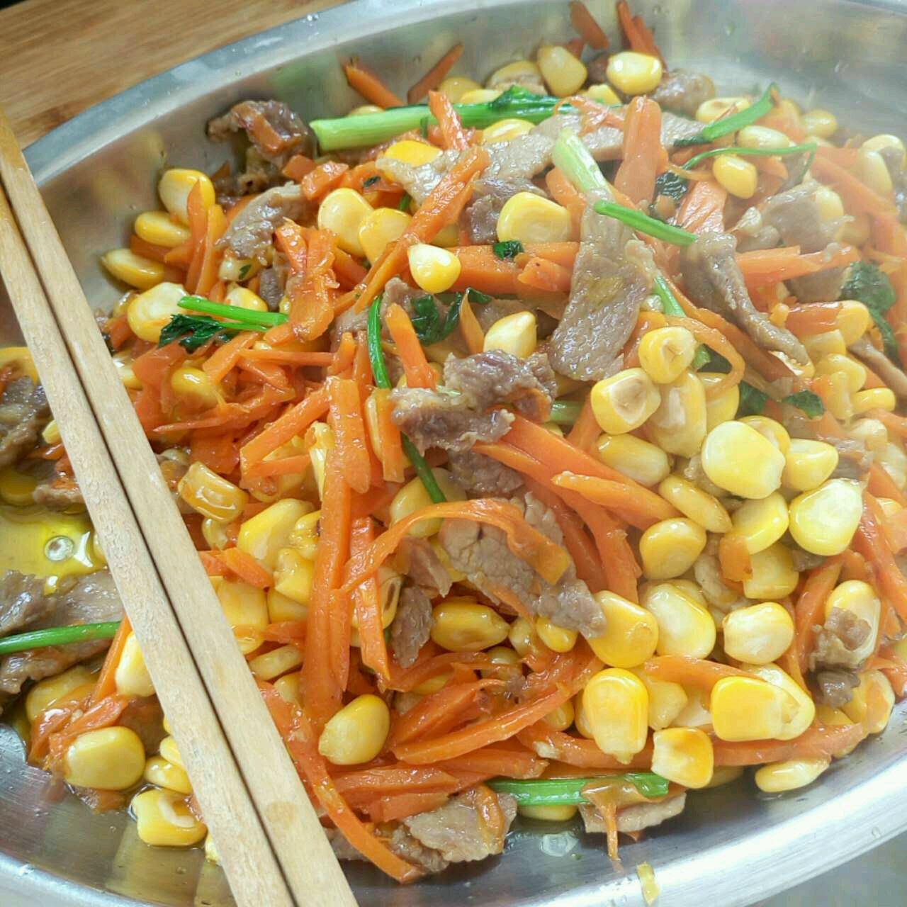 Fried meat with carrot and corn