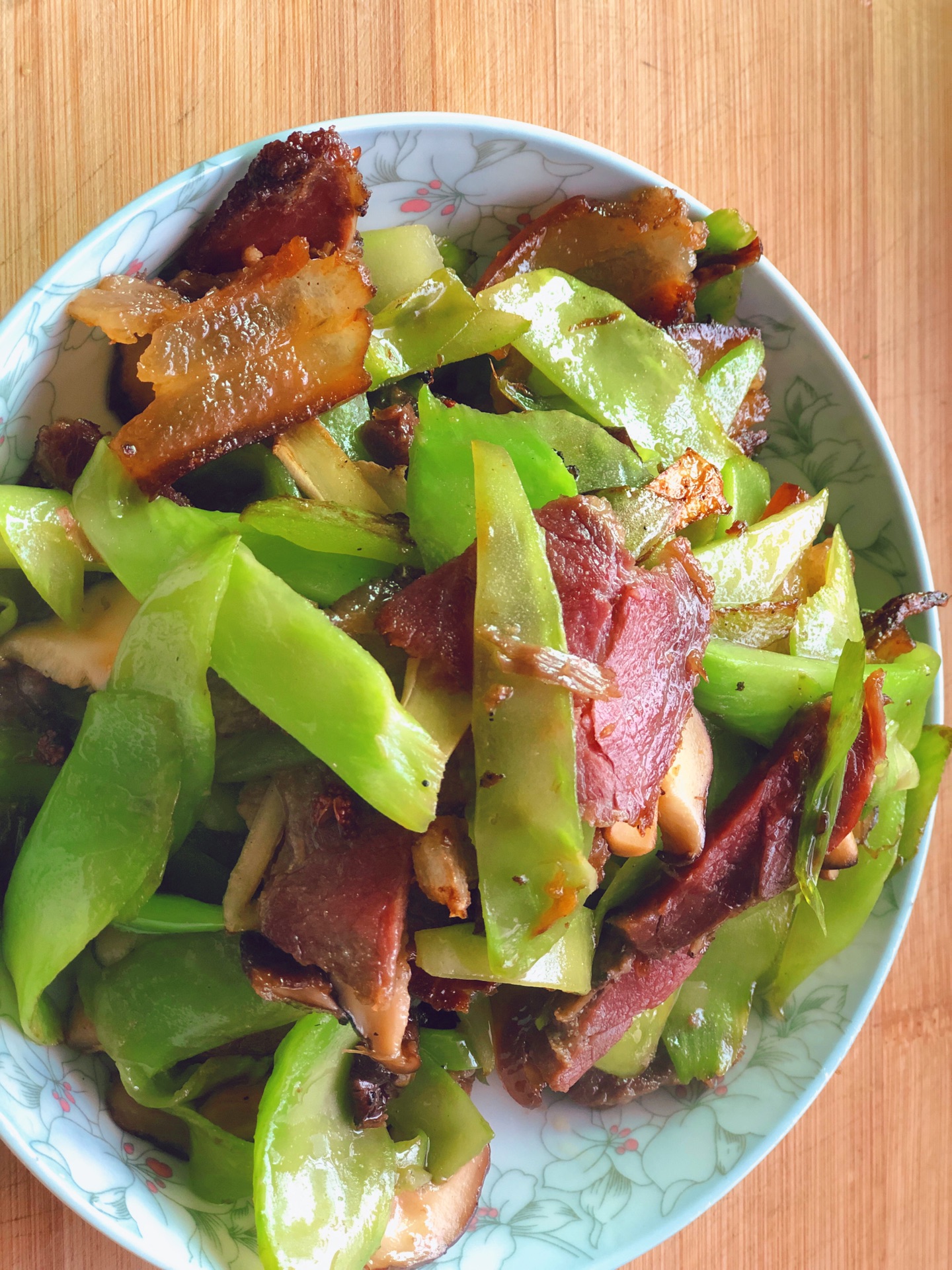 Stir fried green shoots and bacon for two bowls