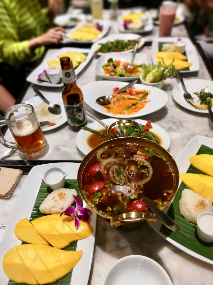 3月17号晚餐：  泰国🇹🇭的天气太闷热了  全方位的防晒也挡不住紫外线的辐射  汗流夹背 体力消耗相当的大  必须吃！ 吃！吃！😂😂😂 还是去了“白花楼” 她们家的菜味道很好  星期天的晚餐  当地人都来餐厅  等了几分钟丫丫外公是食肉族 点了一个大大的烤猪肘 外婆喜欢芒果糯米饭 点了六份 😀😀😀点菜的泰国美女眼睛睁的铜铃大 一脸惊讶🙀 中国阿公阿婆这么能吃～😝😝😝  她们家的饮料也很好喝  😂图1